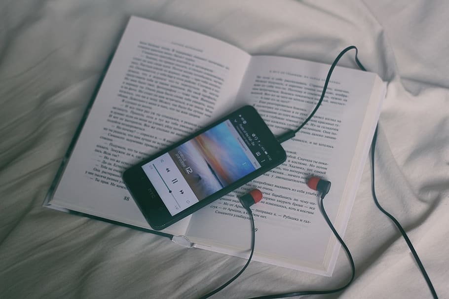 black smartphone on white book page, black smartphone on top of white book HD wallpaper