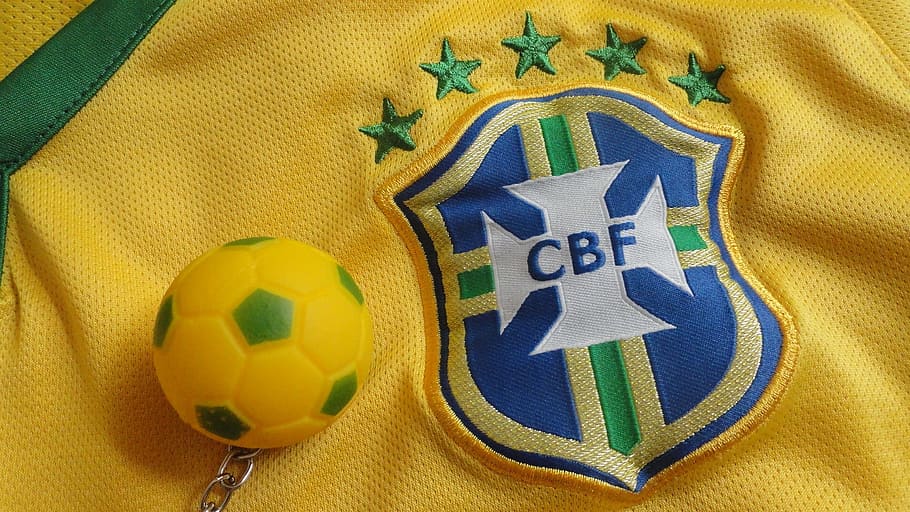 close-up photography of soccer ball keychain on yellow CBF jersey shirt, HD wallpaper