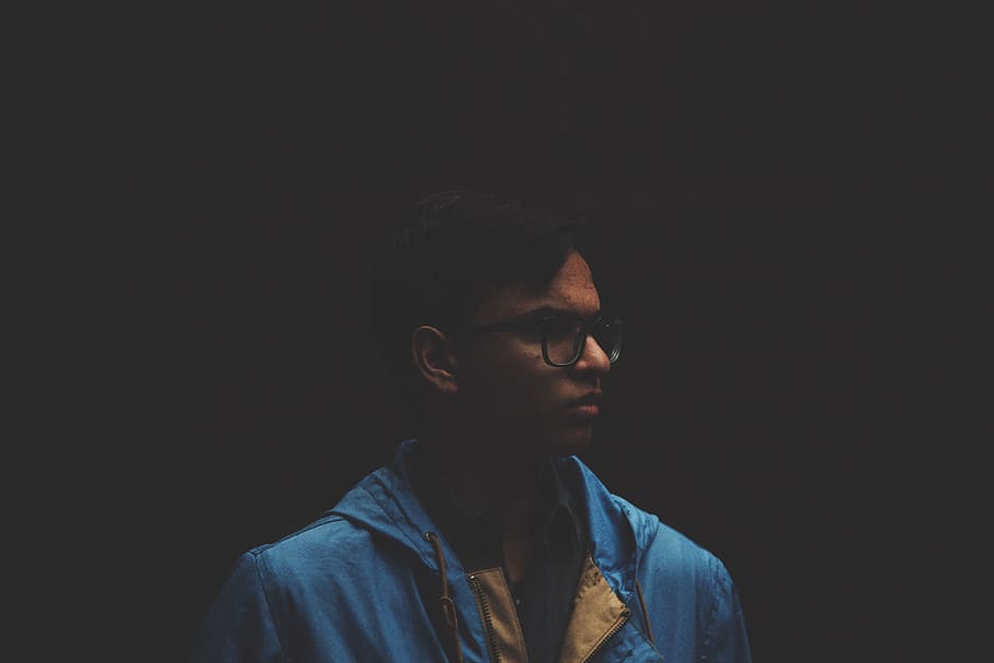 selective focus photo of man with dark background, man wearing eyeglasses HD wallpaper