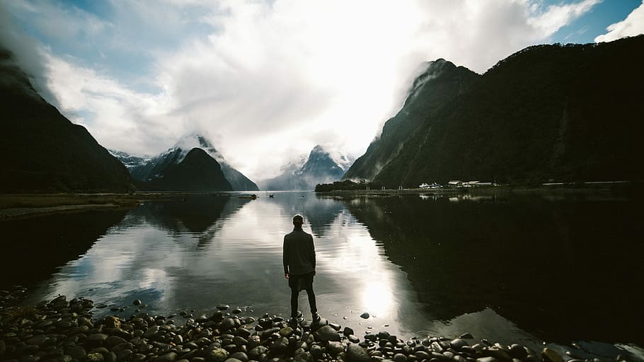silhouette of person in front of body of water during daytime HD wallpaper
