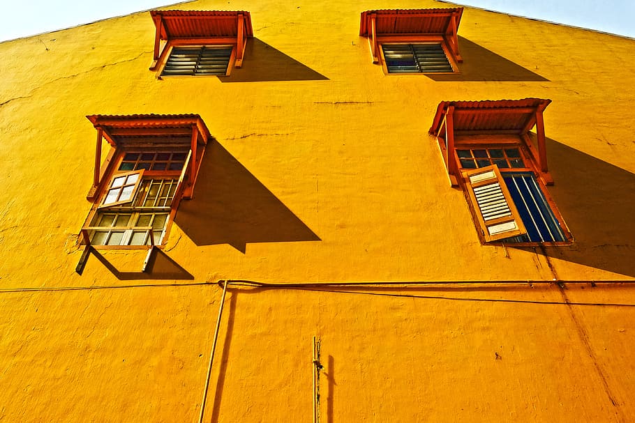 yellow concrete building at daytime, orange concrete building low angle photography HD wallpaper