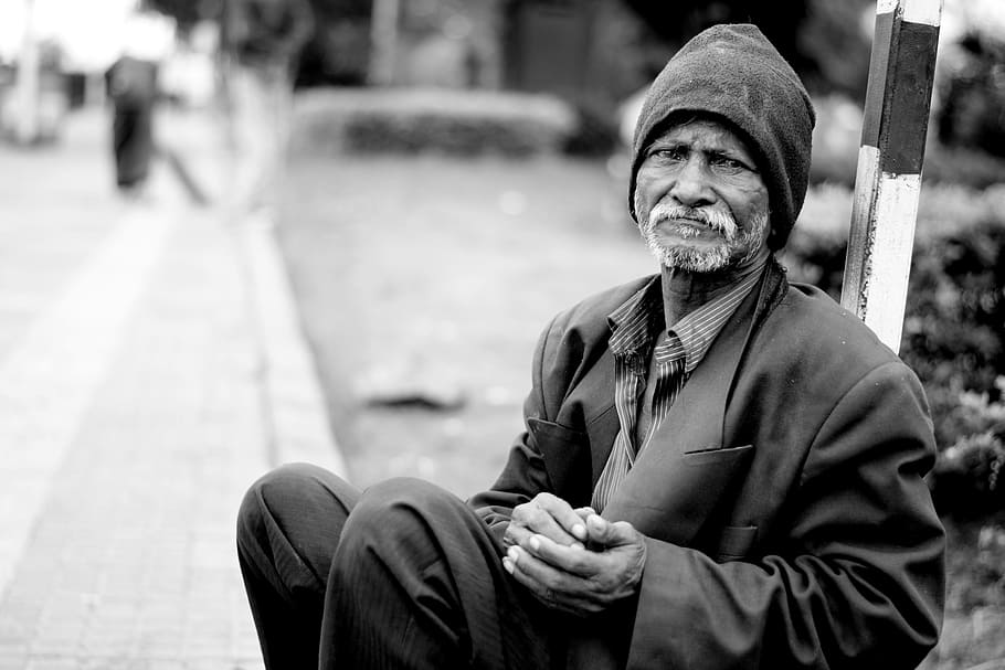 grayscale photo of man wearing black knit cap, poor, poverty