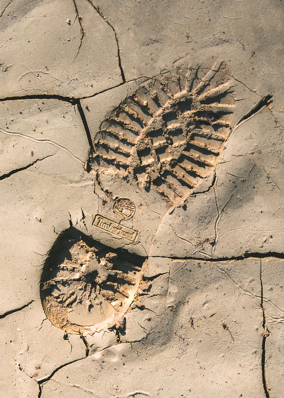 Timberland boot footprint on sand, shoe print on concrete floor