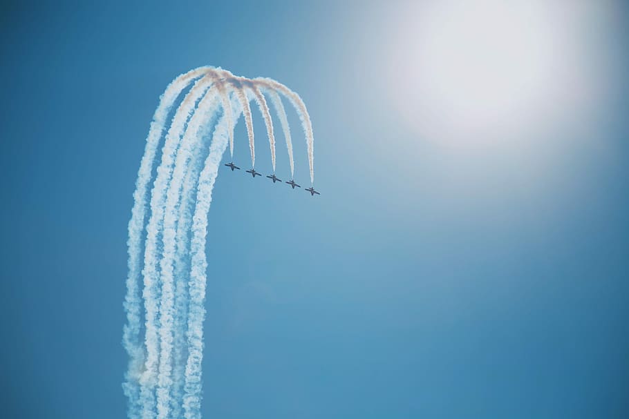five flying jet planes on sky at daytime, jet plane pilot doing cloud tricks
