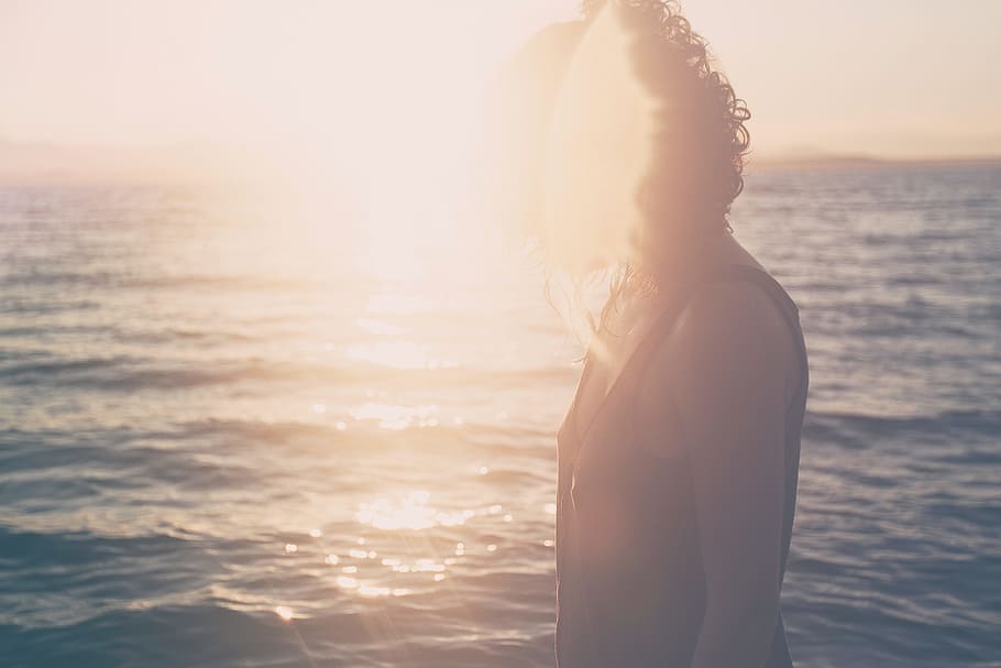 woman wearing black tank top standing beside body of water during sunset, HD wallpaper
