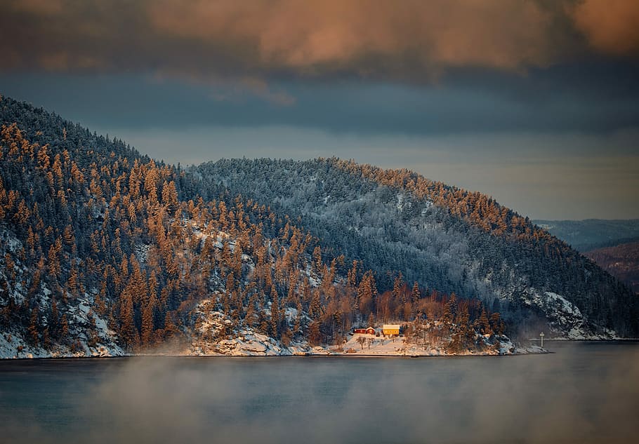 landscape photography of an island, house near body of water surrounded by trees near mountain HD wallpaper