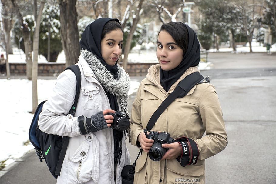 two woman's standing while holding cameras during snow time, Mashhad, HD wallpaper