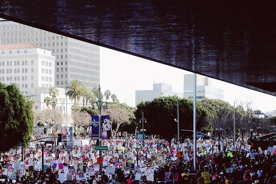 crowd of people near concrete buildings during daytime, group of people having parade HD wallpaper