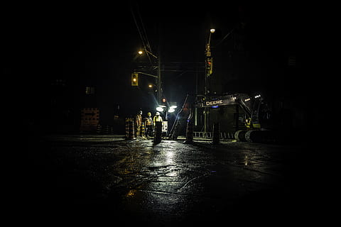 three people standing near utility post with lights turned on during nighttime, untitled HD wallpaper