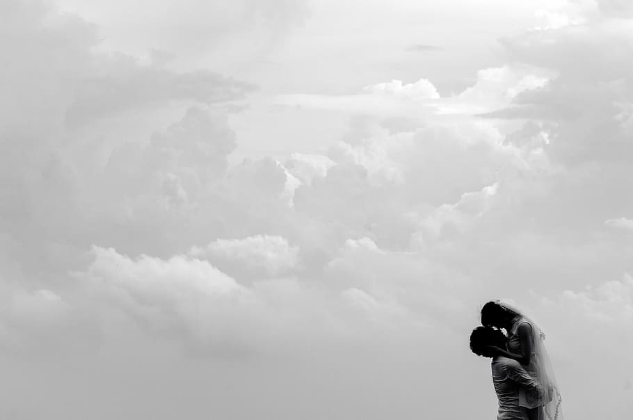 man carrying woman on clouds during daytime, silhouette, couple