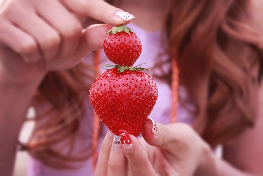 woman holding two strawberry fruits, women, human Hand, close-up HD wallpaper
