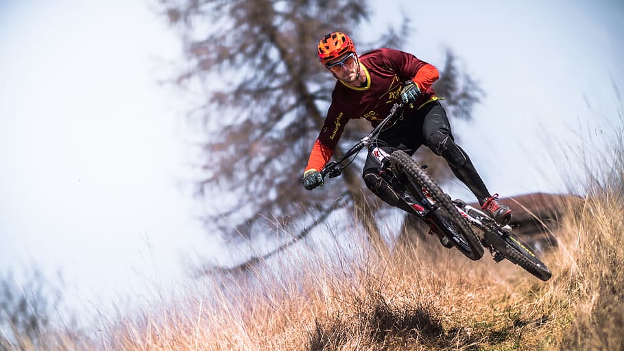 man riding on bicycle, mountain, trees, grass, plants, highland HD wallpaper