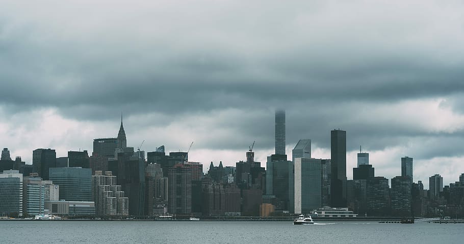 cityscape photography under nimbus clouds, aerial view of high rise buildings under gray sky HD wallpaper