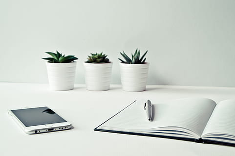 white Android smartphone beside the notebook, white background HD wallpaper