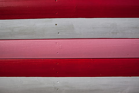 Close-up shot of red, white and pink-coloured wood panels. Image captured in Whitstable, Kent, England HD wallpaper