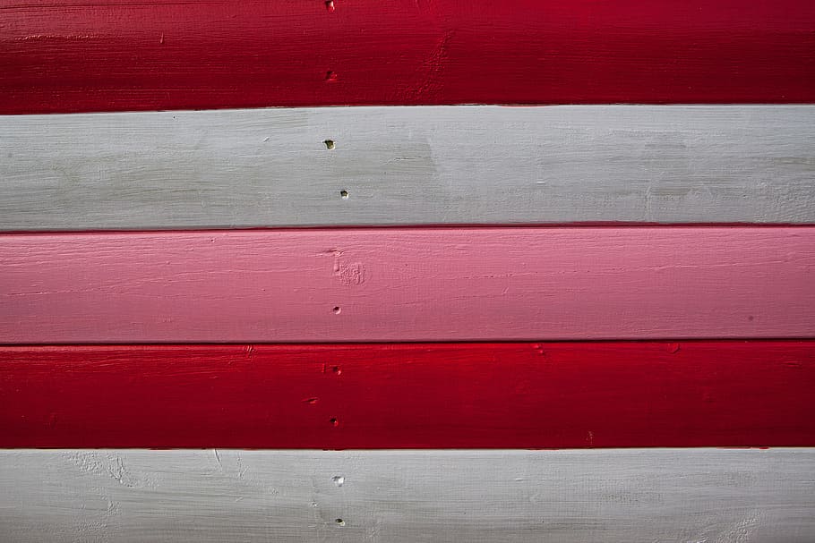 Close-up shot of red, white and pink-coloured wood panels. Image captured in Whitstable, Kent, England, HD wallpaper