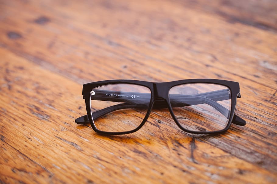 black framed Wayfarer-style eyeglasses on wooden surface, black framed eyeglasses on brown surface HD wallpaper