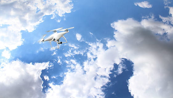 white DJI drone under white clouds and blue sky at daytime HD wallpaper