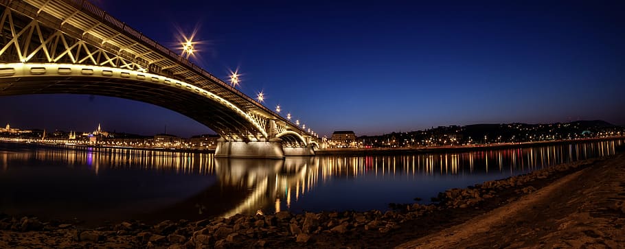 lighted bridge under blue sky, city, mountains, night, buildings HD wallpaper