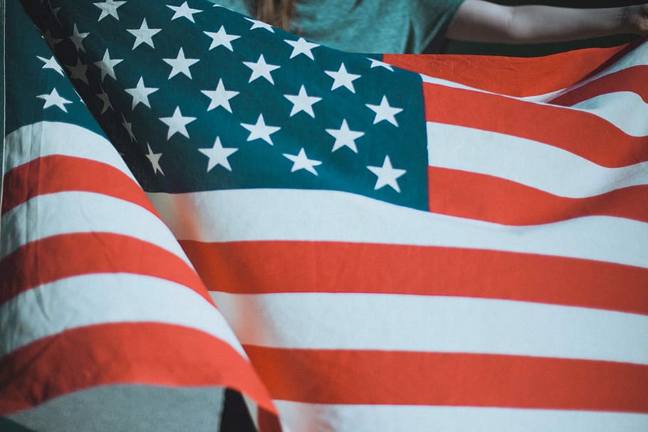 person holding USA flag, person in gray top holding flag of USA HD wallpaper