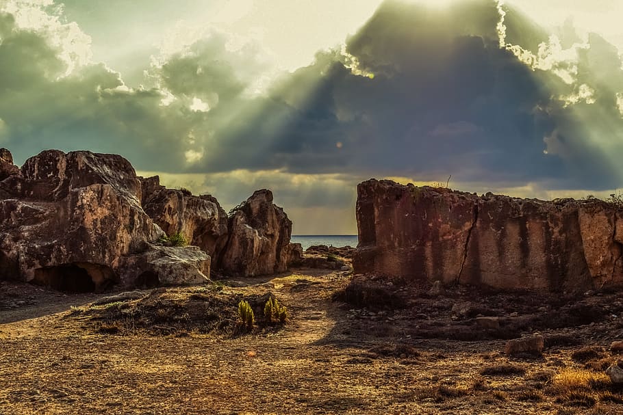 brown cliff near a sea under grey cloudy sky, cyprus, paphos