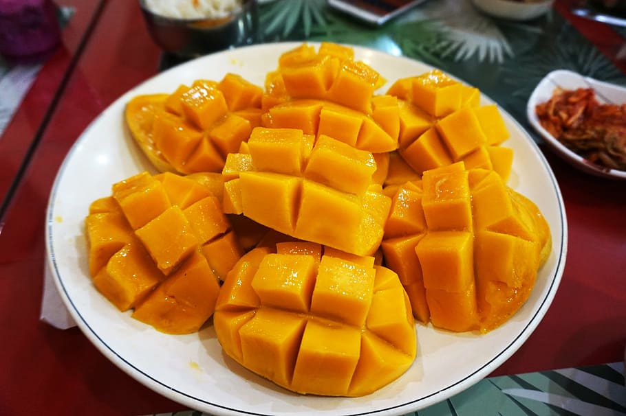 sliced of mango serve on white plate, republic of the philippines