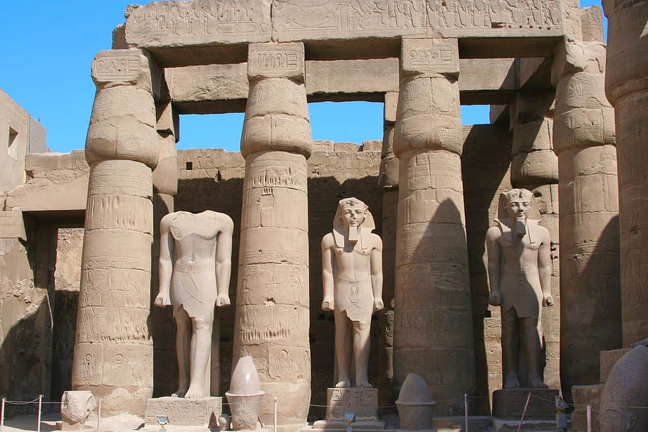 three King Tut statues between pillars, egypt, luxor, karnak temple