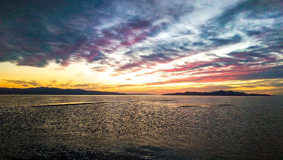 panoramic photography of body of water under golden hour, photo of island silhouette HD wallpaper