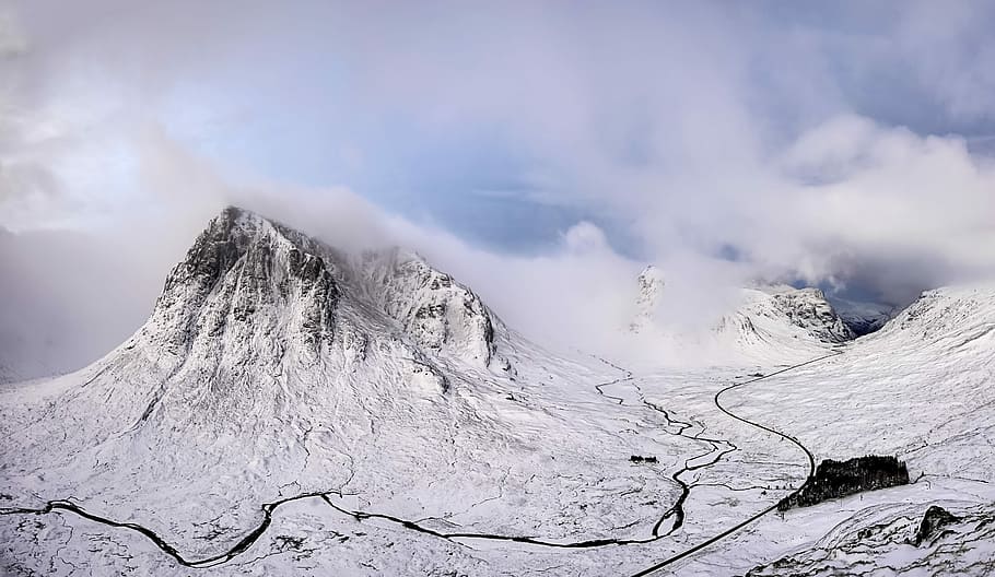 landscape photography of snow covered mountain under cloudy sky, snow-covered mountain surrounded by clouds at daytime HD wallpaper