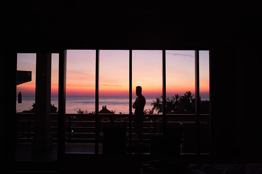 man standing in front of glass wall, silhouette of person standing on veranda HD wallpaper