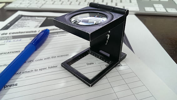 black magnifying glass on white printing paper near blue ballpoint pen HD wallpaper