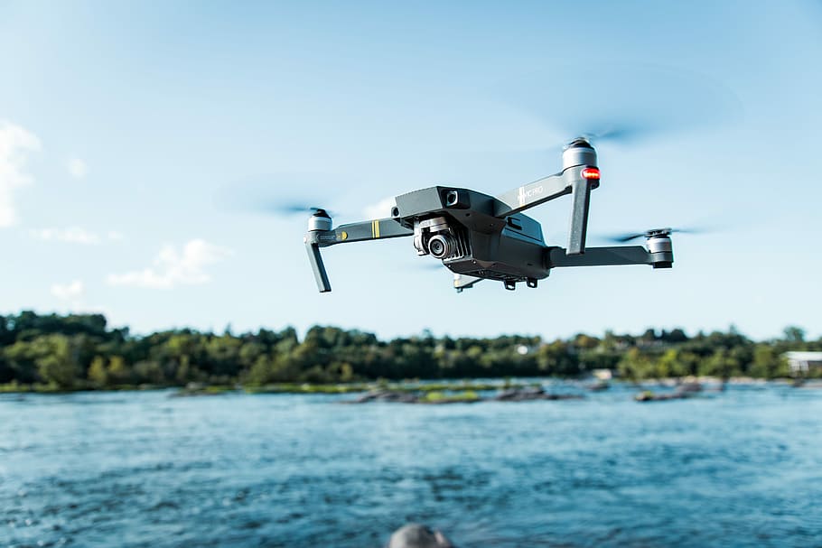 black DJI Mavi quadcopter near body of water, black quadcopter drone flying outdoor during daytime, HD wallpaper
