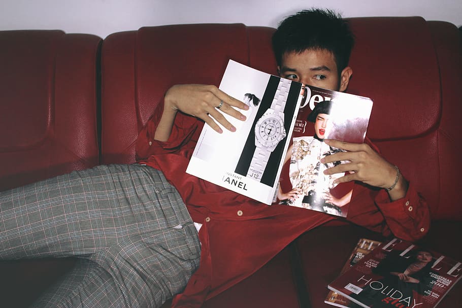 Photography of a Man Holding Magazine, blur, boy, close-up, couch HD wallpaper