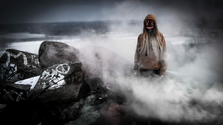 person wearing black mask and brown pullover hoodie, person wearing brown hoodie