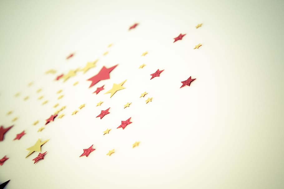 close-up photography of yellow and red star decor, background HD wallpaper