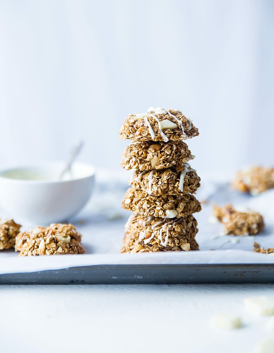stack of foods beside white ceramic bowl, pile of cookies beside dip bowl HD wallpaper