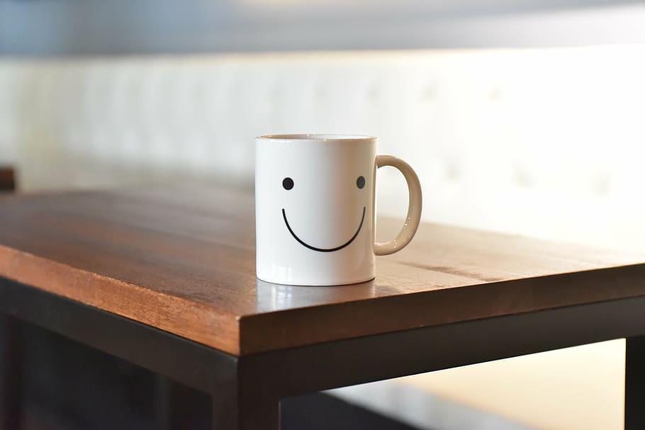 white ceramic mug on brown wooden table, smile, cup, coffee HD wallpaper
