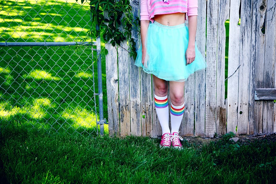 girl's teal skirt, person leaning on wall, retro, crop top, clothing
