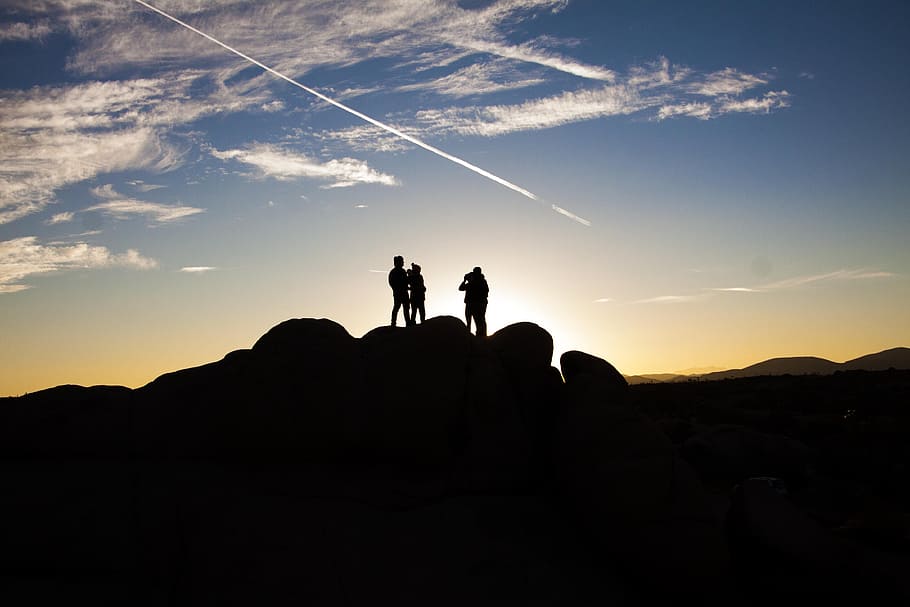Silhouette Photo of People on Top of Rock Formation, backlit HD wallpaper