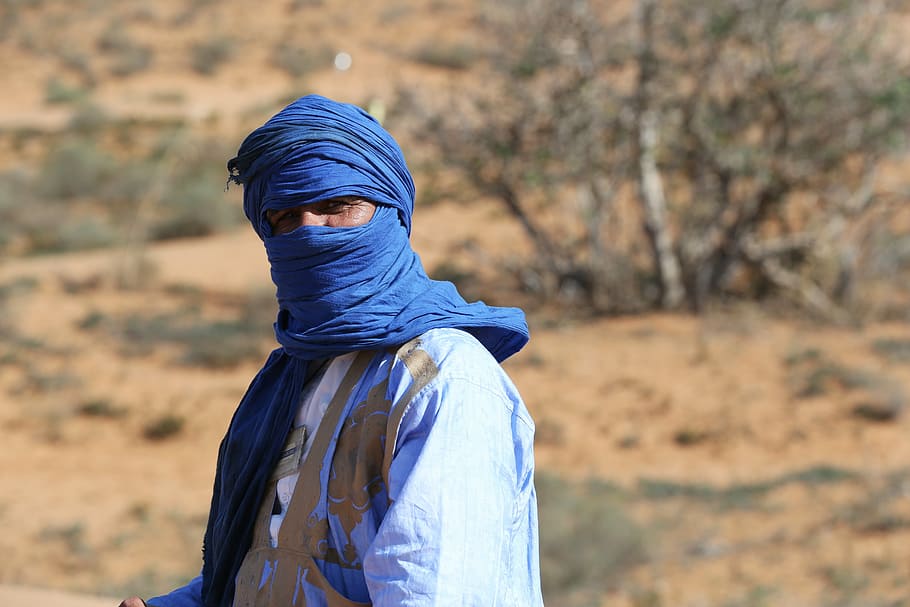 macro photography of man in blue hijab, sahara, morocco, tourism