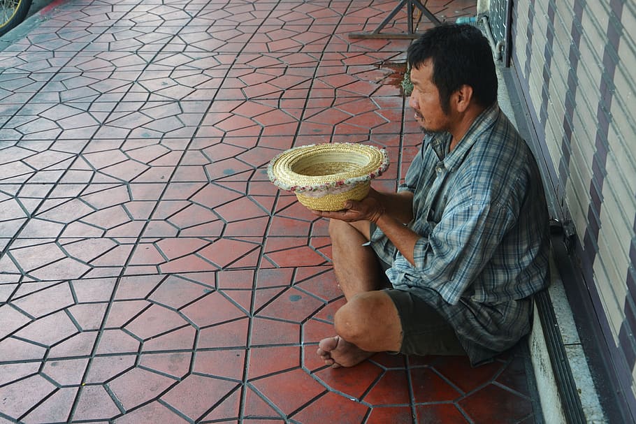 man sitting on brown ceramic tiles, beggar, begging, street, poverty