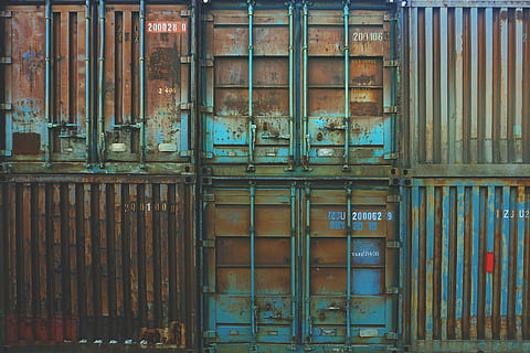 six blue freight containers, several brown cargo containers, metal HD wallpaper