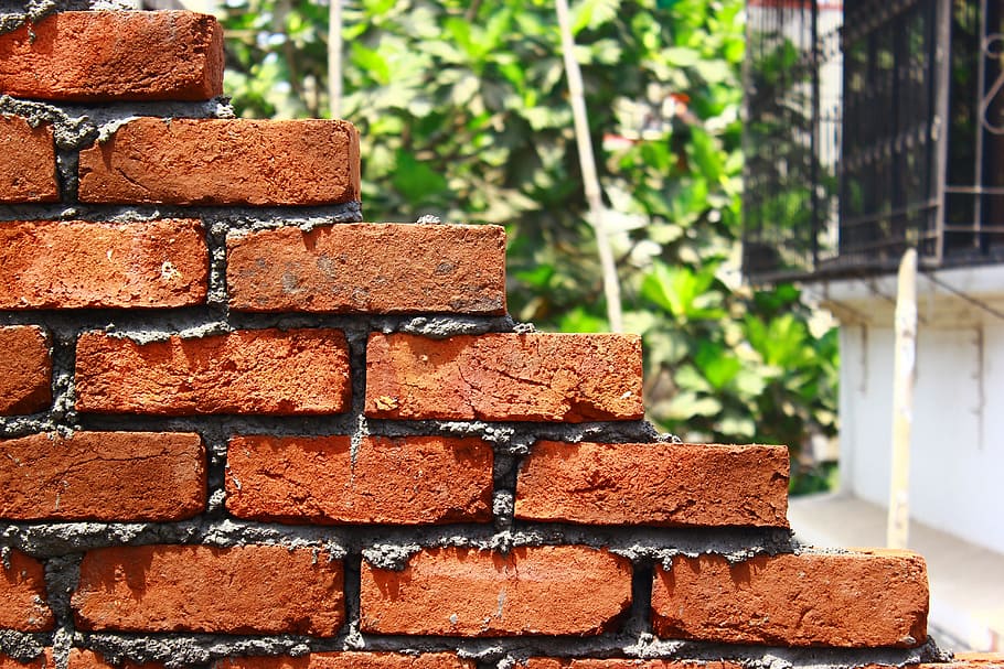 brown brick wall near white house close-up photography, Bricks
