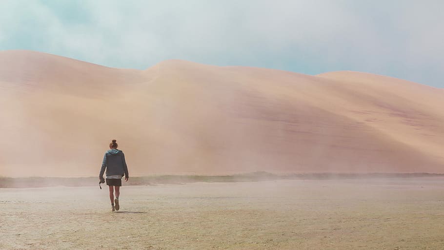woman walking on desert, person walking along desert during daytime HD wallpaper