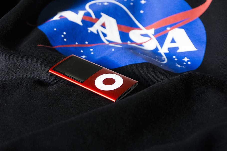 turned off red iPod Nano 5th gen., closeup photo of 5th generation iPod nano on black cloth