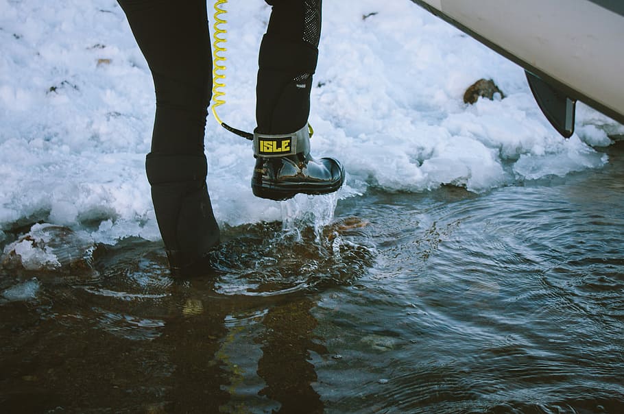 person about to step on ice path, person in water carrying surfboard HD wallpaper