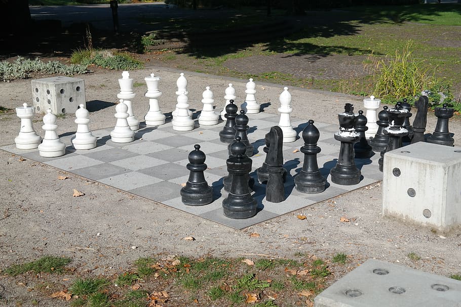black and white concrete chess, chess board, chess pieces, chess game