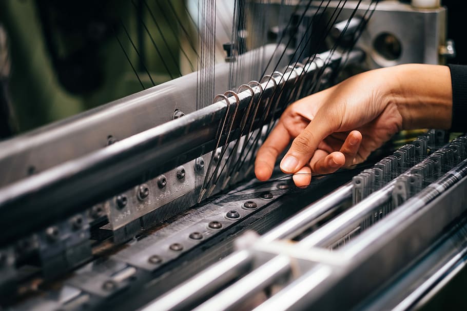 person fixing machine, person holding black string, factory, textile HD wallpaper