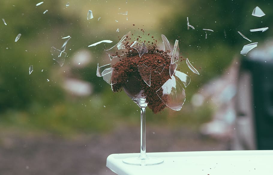 selective photography of broken wineglass filled with brown powder HD wallpaper