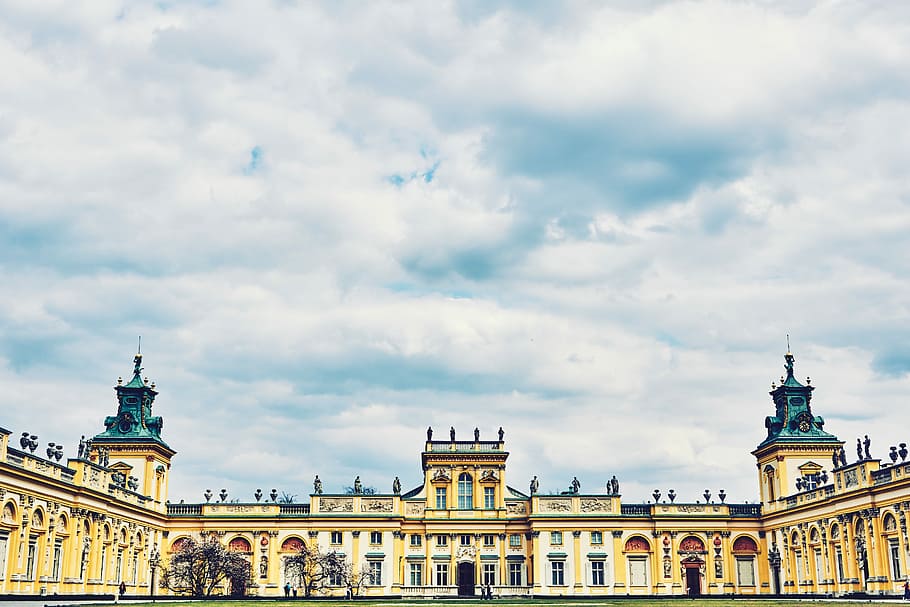 yellow concrete building during daytime, yellow concrete building under white sky at daytime HD wallpaper